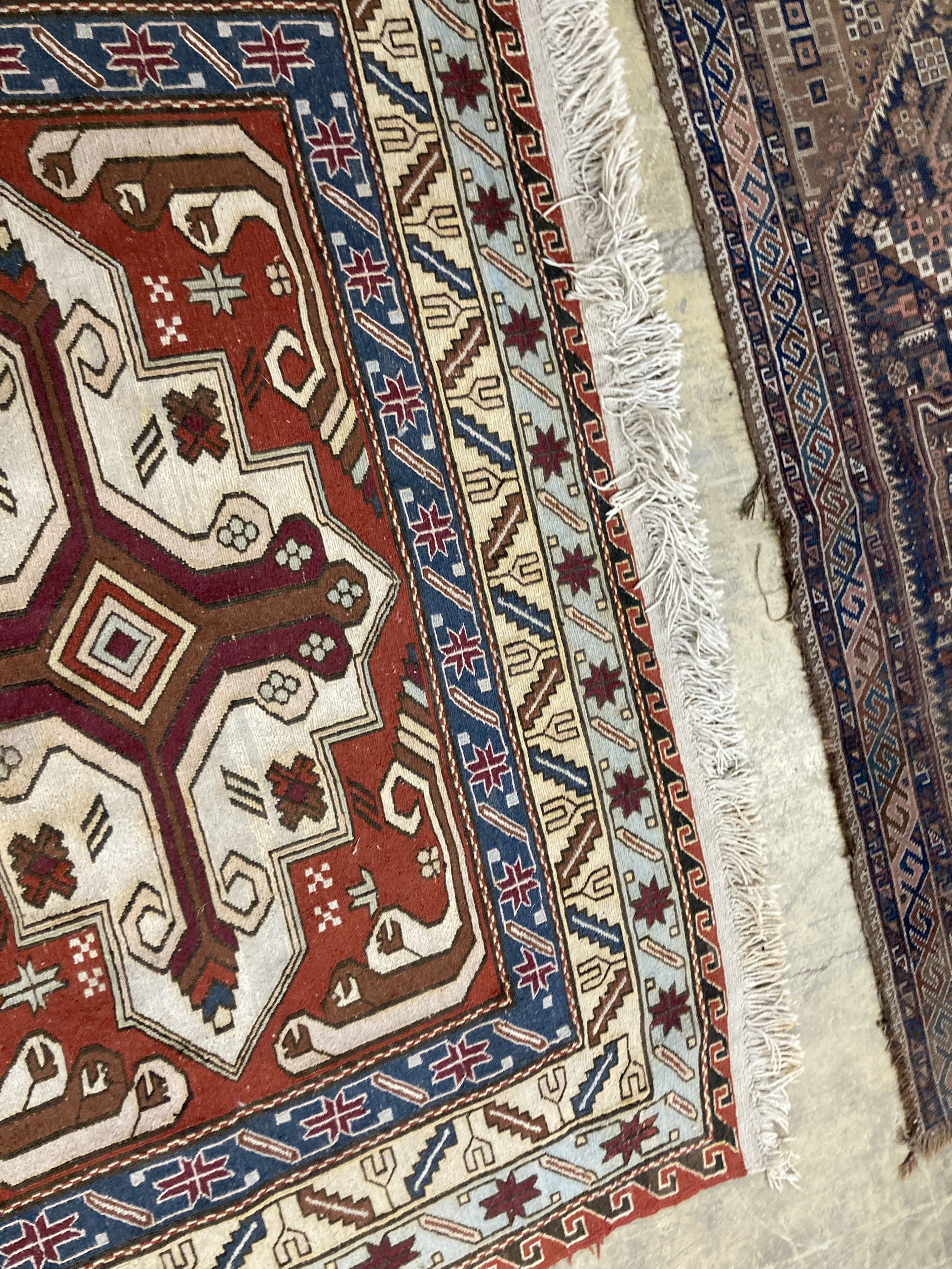 A Caucasian design red ground rug, 240 x 165 cms.